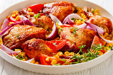 roast chicken with corn and tomatoes on plate