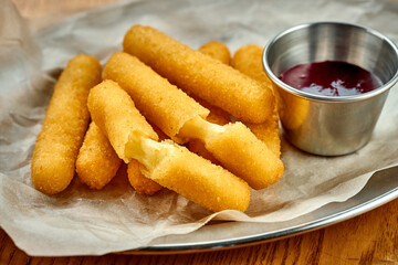 An appetizer for beer - breaded stick mozzarella fries. Close-up, selective focus