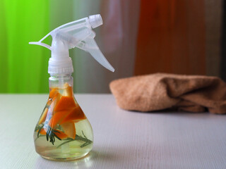 Spray bottle of rosemary and orange flavored vinegar