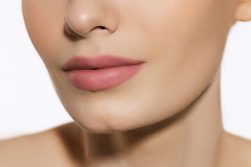 Obraz na płótnie Canvas Closeup female lips, cheeks and nose isolated over white studio background. Concept of cosmetology, skincare, cosmetics, plastic surgery, ad
