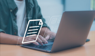 worker typing on laptop keyboard to document management system (DMS) or databases, concept of using...