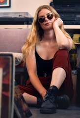Fototapeta na wymiar Punk woman, grunge fashion and rock hipster, retro model and confident female with glasses on floor. Portrait of young gen z, cool girl and attitude in creative style, urban fashion and trendy youth