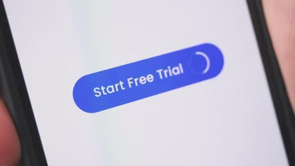 Young lady pressing start free trial button on smartphone. E-commerce concept.