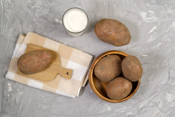 Potato milk in glass and potato. Plant based milk replacer and lactose free.