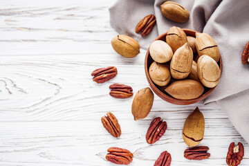 delicious fresh pecans on a white wooden rustic background