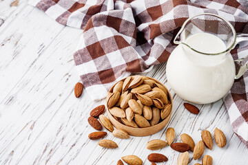 almond milk on a white wooden rustic background