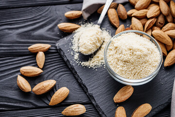 almond flour on a black wooden rustic background
