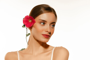 Fototapeta premium Portrait of young beautiful girl with well-kept skin and light daily makeup isolated on white background. Beauty, spa, cosmetics, face lifting and skin care concept