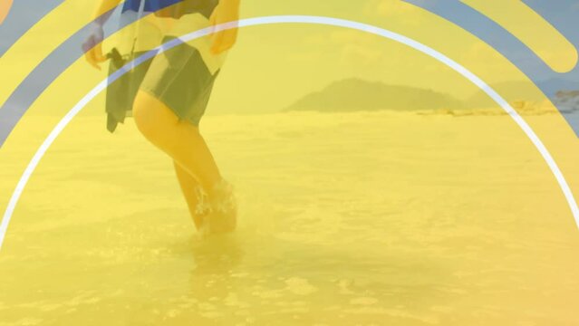 Animation of circles over caucasian woman at beach