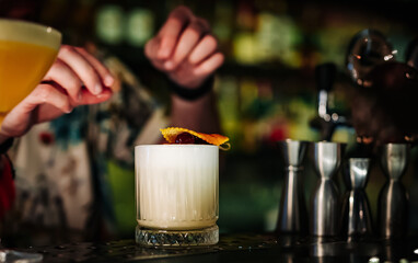 man hand bartender making white cocktail in glass on the bar counter