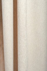 vertical shot of beige blackout curtains made of textured canvas, unbleached natural fabric. good night sleep, light block for melatonin production.