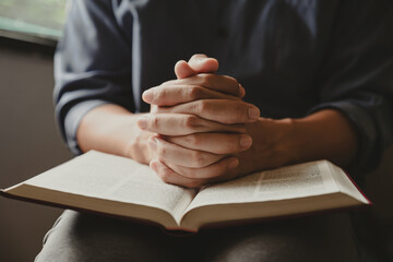 Hands of man praying to god with the bible, Concept of faith for god.