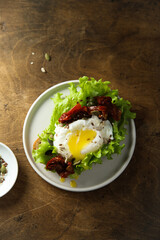 Poached egg on toast with sun dried tomatoes