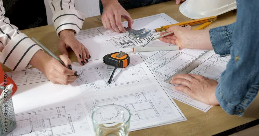 Poster colleagues architects are working on a construction project. design drawings on the desktop of build
