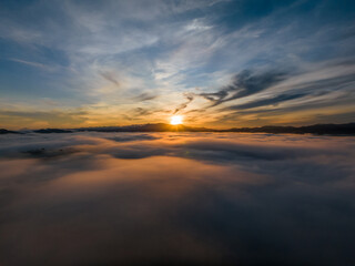 Aerial view drone flying over sea of fog at sunrise, Khoa Khai nui mountain, Phang Nga, Thailand.
