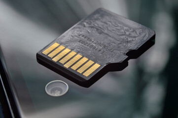 micro sd card lies on the smartphone screen. close-up