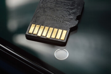 micro sd card lies on the smartphone screen. close-up