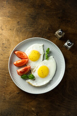 Roasted eggs with tomatoes and basil