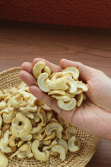 Heap of Dried Cashew Nut Kernels in Man's Hand