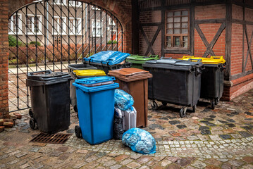 Garbage cans in different colors symbolizing recycling on the street