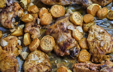 Chicken with sweet potatoes and garlic, baked with mayonnaise in a home oven. Fast kitchen.