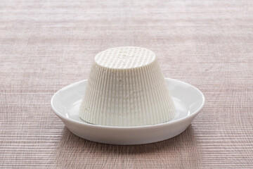cottage cheese on white plate with wooden background