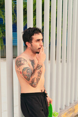 Fototapeta na wymiar Young Hispanic smoking a cigarette on a sunny day