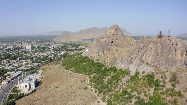 Panorama of the city of Osh from a bird's-eye view. Sulaiman-Too is a rocky sacred mountain and a symbol of the city of Osh. The amazing nature of Kyrgyzstan. Beautiful mountains.