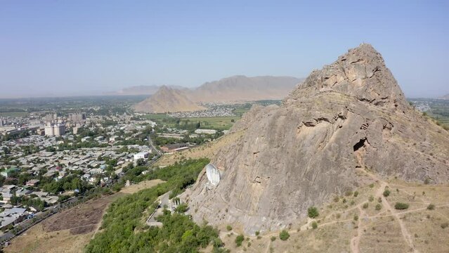 The rocky sacred mountain and the symbol of the city of Osh is Sulaiman-Too. Beautiful mountains. Panorama of the city of Osh from a bird's-eye view. The amazing nature of Kyrgyzstan.