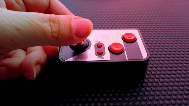 remote control on dark background, red button, finger presses red button, joystick control, threat of using nuclear, chemical weapons of mass destruction, concept Rocket launch at push of button