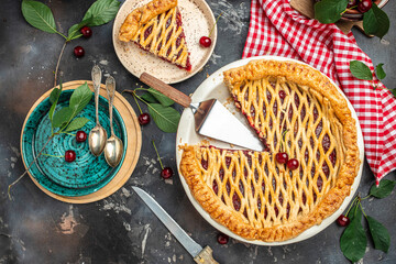 Delicious Homemade Cherry Pie, Flaky Crust, piece on a plate and the whole homemade cherry pie, top view