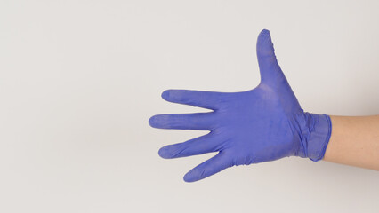 Empty Hand wear purple latex gloves on white background.