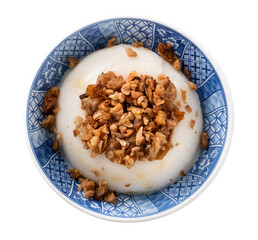 Taiwanese savory rice pudding Wa gui with chopped dried radish and soy sauce isolated on white...