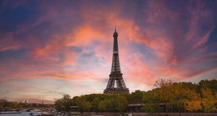 The Eiffel Tower, iconic Paris landmark  as autumn trees park  as Seine river with sunset sky scene in Paris ,France