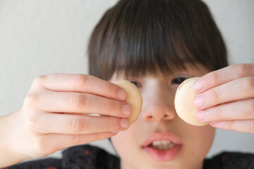 close-up of part of the child's face, boy 10-12 years old Asian-European appearance, makes...
