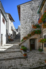 A narrow street between the old stone houses of Barrea, a medieval village in the Abruzzo region of Italy.