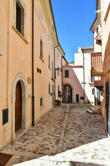 A narrow street between the old stone houses of Barrea, a medieval village in the Abruzzo region of Italy.