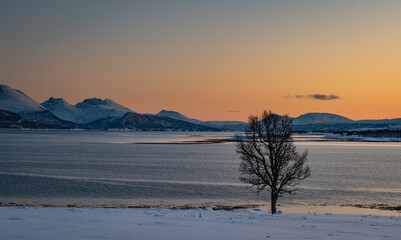 Sunset over the Norwegian fjord, winter photos at the golden hour, Tromso, Norway