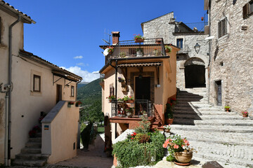 A narrow street between the old stone houses of Barrea, a medieval village in the Abruzzo region of Italy.