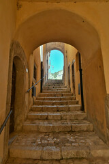 A narrow street between the old stone houses of Barrea, a medieval village in the Abruzzo region of Italy.