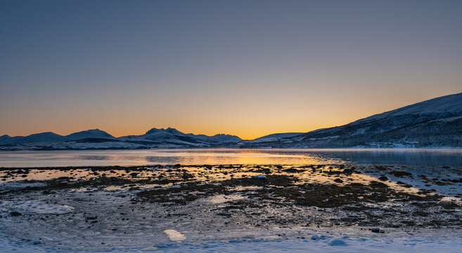 Sunset over the Norwegian fjord, winter photos at the golden hour, Tromso, Norway