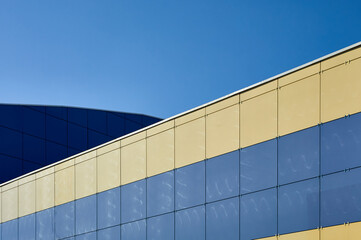 The walls of the building are tiled, the clear blue sky harmonizes with the blue tiles on the building, geometric still life