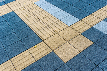 Tactile tiles at the crossing of the road in Tokyo city in Japan