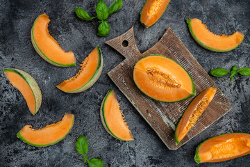 sliced cantaloupe melon. Raw Organic Tuscan Melon Cantaloupe on dark background, top view