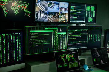 Computer monitor space with live camera views and multiple data located on dark room of hacker base