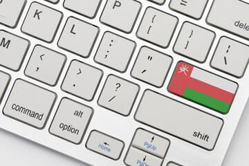 national flag of oman on the keyboard on a grey background .3d illustration