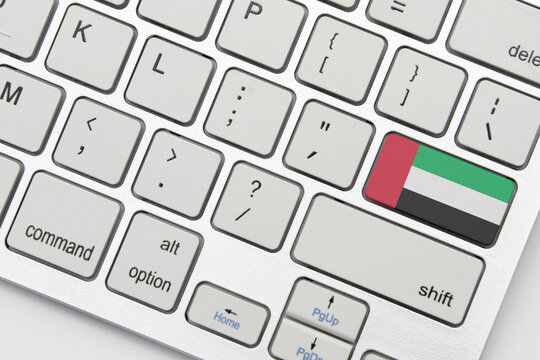 national flag of united arab emirates on the keyboard on a grey background .3d illustration