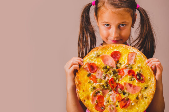 Concept of fast food, pizzeria. Pretty young girl with snack of pizza.  Copyspace.