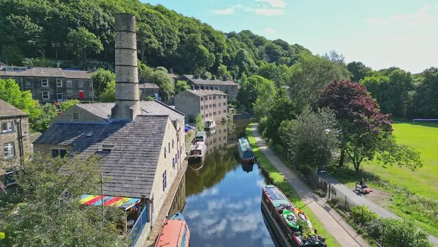 Aerial video footage of Hebden Bridge a lovely old textile mill town on the Rochdale Canal in West Yorkshire England. Showing Locks, Canal Boats, Barges, and old world houses.