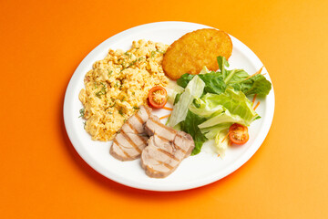 Traditional breakfast. Fried eggs, meat and hash brown in a plate.